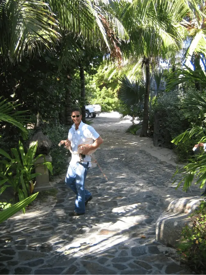 Unlabeled DOJ dataset photo showing a man walking on a stone path at a tropical property